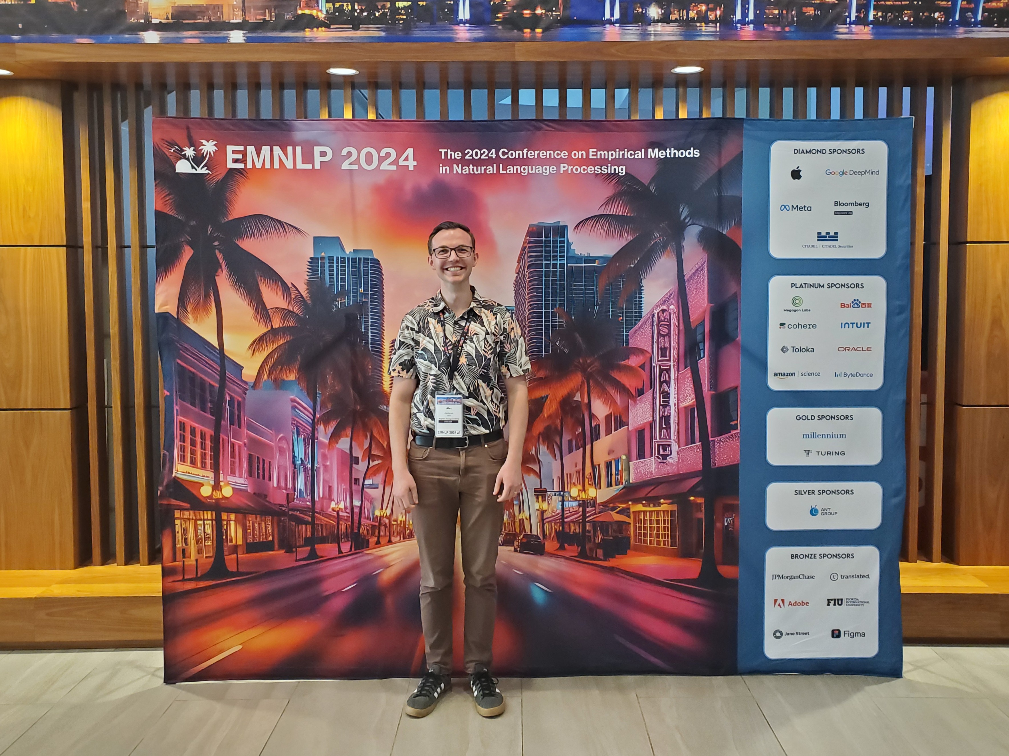 Me at the EMNLP 2024 entrance/backdrop