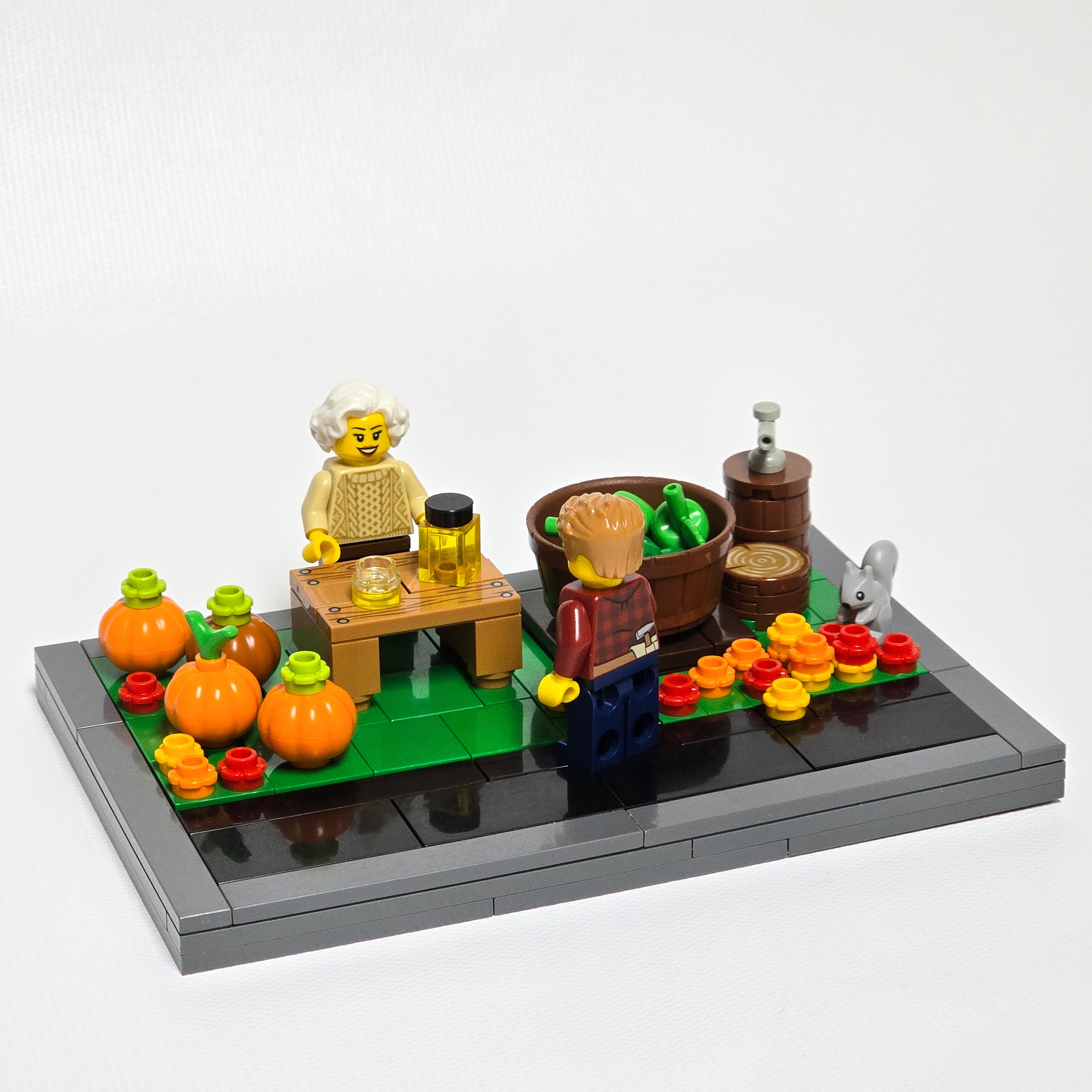 Lego fall farm stand selling apple cider and pumplkins, created by Alex Lyman
